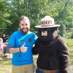 Young State Park Explorer Guide Devin Burke poses with Smokey the Bear during Free Fishing Weekend, June 11-12, 2016.