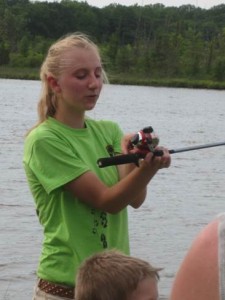 Former Proud Lake explorer guide Liz Kotnik explains the parts of a rod and reel before a fishing program. Her sister Lynn is now the explorer guide for the park.