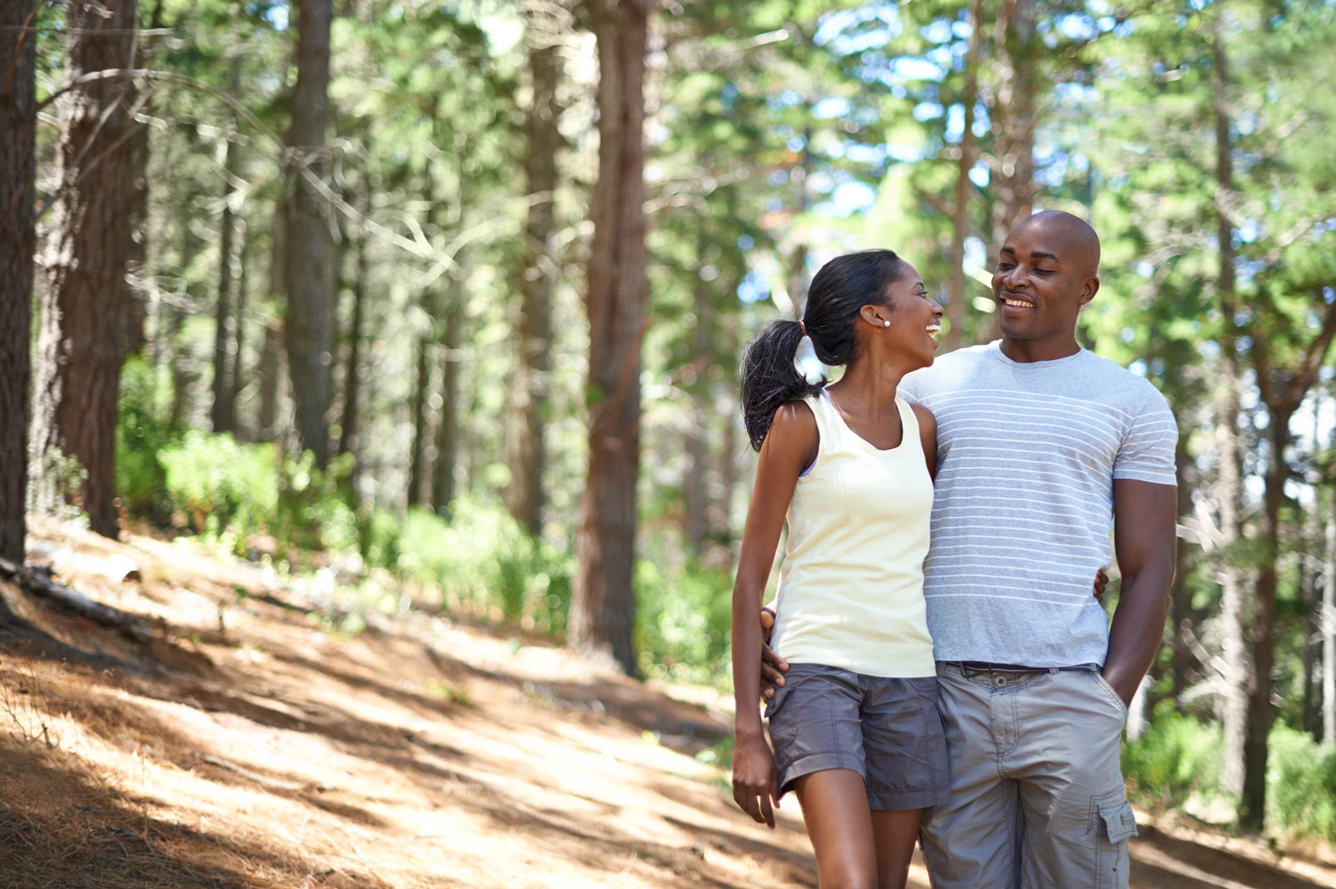 Couple walking through forest