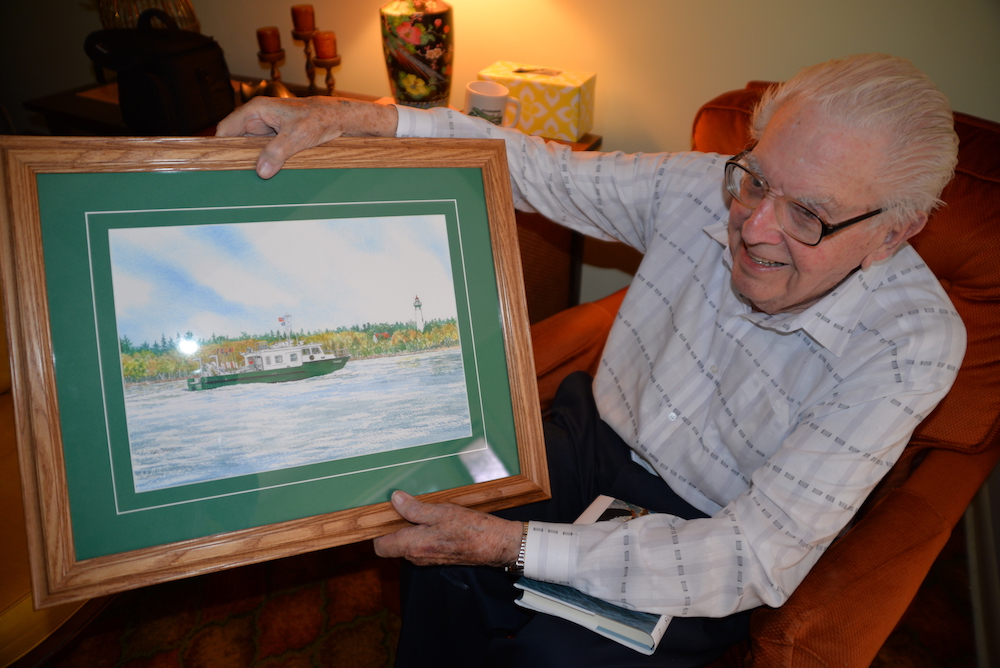 Howard Tanner shows off a painting of the Research Vessel Tanner
